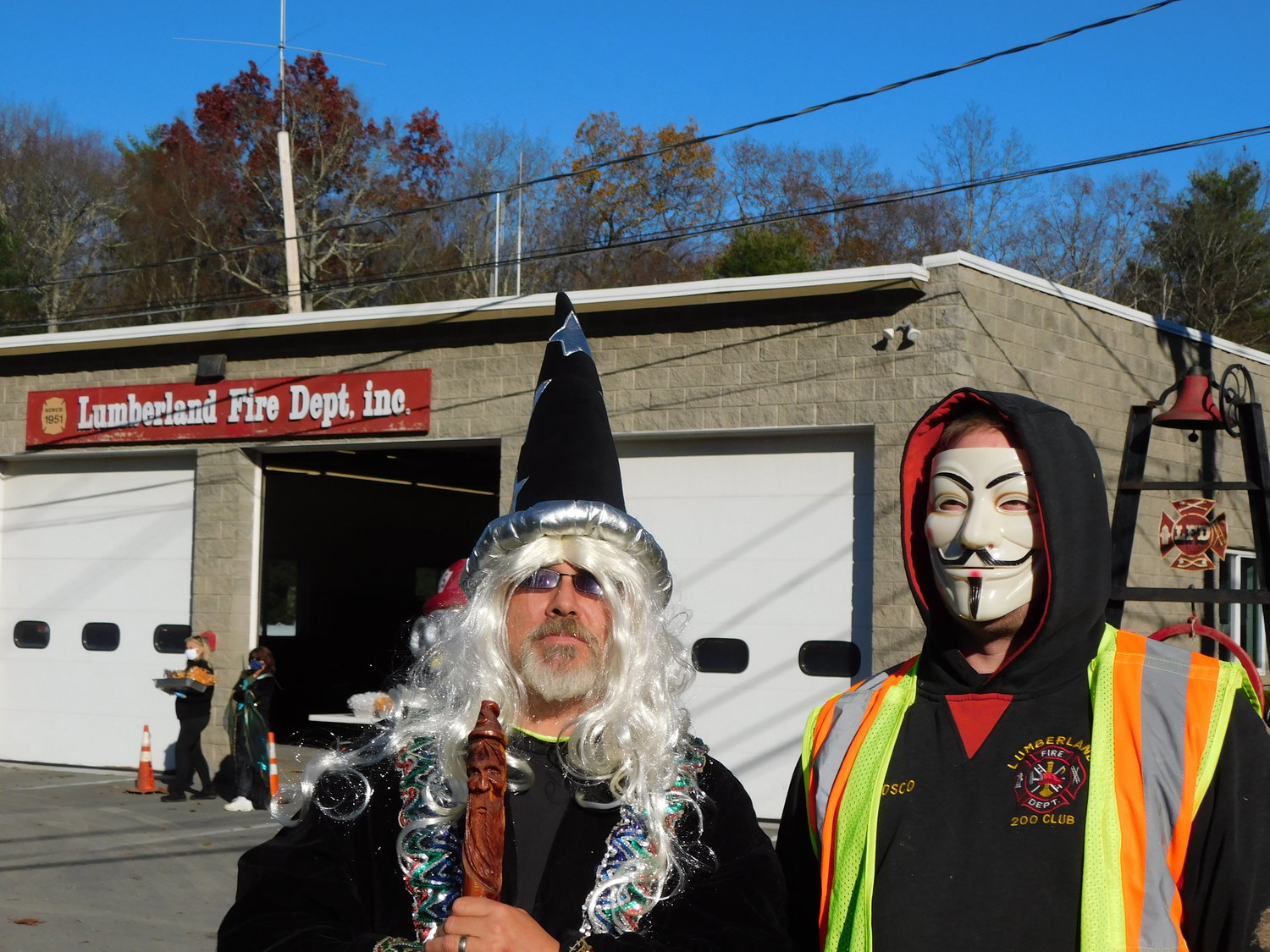 The Wizard is fireman Eric Robles and the man in the Guy Fawkes mask is fireman Don “Bosco” Hunt.